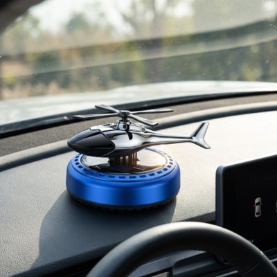 Diffuseur de parfum bleu ronde installé sur tableau de bord voiture