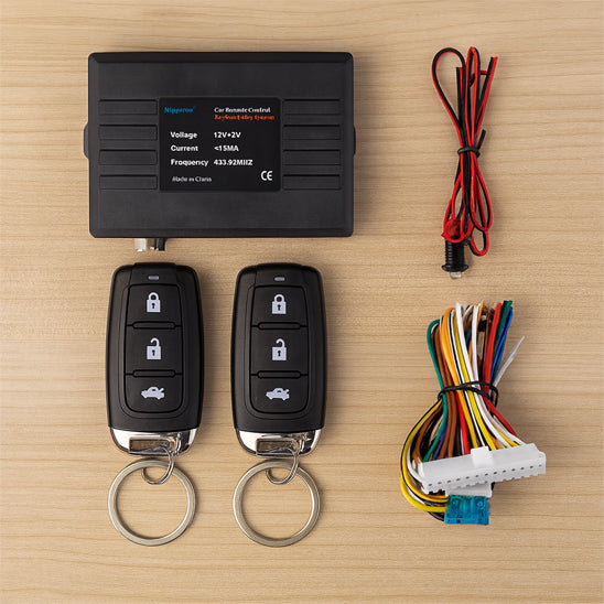 Kit alarme auto avec boîtier de commande, deux télécommandes et faisceau de câbles pour installation 